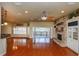 Spacious living room featuring hardwood floors, a stone fireplace, and sliding glass doors to the outdoor deck at 6065 Spruce Point Cir, Port Orange, FL 32128