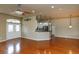Inviting living room featuring an open floor plan, hardwood floors, and a seamless connection to the kitchen at 6065 Spruce Point Cir, Port Orange, FL 32128