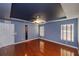 Main bedroom with hardwood floors, a unique tray ceiling, and plenty of natural light from the windows at 6065 Spruce Point Cir, Port Orange, FL 32128