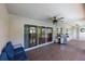 Covered patio featuring a ceiling fan, stainless steel grill, and sliding glass doors for indoor/outdoor living at 6065 Spruce Point Cir, Port Orange, FL 32128