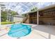 Enjoy the outdoors in the screened pool area, featuring a deck with stairs and plenty of space to relax and play at 6065 Spruce Point Cir, Port Orange, FL 32128