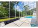 Enjoy the private screened-in pool with outdoor space and lush landscaping, perfect for relaxation and entertainment at 6065 Spruce Point Cir, Port Orange, FL 32128