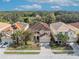 Aerial view of a house and neighborhood with houses and lush greenery at 5244 Oakbourne Ave, Davenport, FL 33837