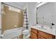 Clean bathroom with tan tile and wood vanity at 5244 Oakbourne Ave, Davenport, FL 33837