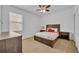 Cozy bedroom with wood bed frame and neutral decor at 5244 Oakbourne Ave, Davenport, FL 33837