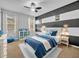 Nautical-themed bedroom with white bed frame and blue bedding at 5244 Oakbourne Ave, Davenport, FL 33837