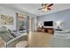 Living room with light walls, gray recliner, and access to a patio at 5244 Oakbourne Ave, Davenport, FL 33837