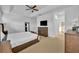 Relaxing main bedroom with a large bed and ensuite bathroom access at 5244 Oakbourne Ave, Davenport, FL 33837