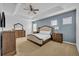 Main bedroom with beige bedding and ceiling fan at 5244 Oakbourne Ave, Davenport, FL 33837