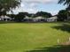 Expansive backyard featuring well-manicured green lawns and a view of the surrounding community homes at 3918 Doune Way, Clermont, FL 34711