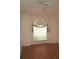 Bright bedroom with wood-look flooring and a large window allowing ample natural light at 3918 Doune Way, Clermont, FL 34711