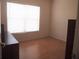 Cozy bedroom with hardwood floors and large window, offering natural light and a serene atmosphere at 3918 Doune Way, Clermont, FL 34711