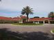 Beautiful building exterior with a circular driveway and professionally landscaped entrance at 3918 Doune Way, Clermont, FL 34711