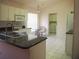 Well-lit kitchen with a sink, granite countertops, stainless steel appliances, and tile flooring at 3918 Doune Way, Clermont, FL 34711