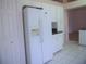 White refrigerator with in-door water dispenser and ample storage, complemented by white cabinetry and granite countertops at 3918 Doune Way, Clermont, FL 34711