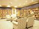 Cozy library featuring bookshelves filled with reading materials and comfortable chairs for relaxation and learning at 3918 Doune Way, Clermont, FL 34711