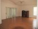 Open concept living room with a ceiling fan, sliding glass doors, and gleaming wood-look flooring at 3918 Doune Way, Clermont, FL 34711