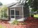 Charming screened-in patio offers a serene outdoor retreat with views of the surrounding landscape at 3918 Doune Way, Clermont, FL 34711