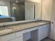 Bathroom features granite countertops, double sinks, and a glass-enclosed shower at 515 Ingleside Ln, Haines City, FL 33844