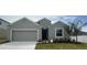 Charming single-story home with a well-manicured lawn and attached two car garage at 515 Ingleside Ln, Haines City, FL 33844