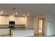 Bright kitchen features white cabinetry, granite countertops, and stainless steel appliances at 515 Ingleside Ln, Haines City, FL 33844