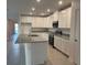 Modern kitchen featuring granite countertops, stainless steel appliances, and a spacious island at 515 Ingleside Ln, Haines City, FL 33844