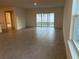 Bright and airy living room with tile flooring and sliding glass doors to the backyard at 515 Ingleside Ln, Haines City, FL 33844