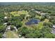 Aerial view showcasing lush greenery, a serene pond, and ample parking for boats and vehicles at 10290 Buck Rd, Orlando, FL 32817