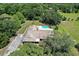 Overhead view showcasing the house, yard, swimming pool, and mature trees from above at 10290 Buck Rd, Orlando, FL 32817