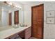 Bathroom features large vanity area, floral wallpaper, and wood shutter doors at 10290 Buck Rd, Orlando, FL 32817