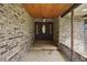 Inviting covered entryway with brick accents, tile flooring, and a stately front door at 10290 Buck Rd, Orlando, FL 32817