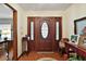 Elegant foyer featuring a wood floor, decorative front door, and classic accents at 10290 Buck Rd, Orlando, FL 32817