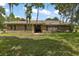 Charming single-story brick home with a tile roof, mature trees, and a spacious front yard at 10290 Buck Rd, Orlando, FL 32817