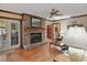 Comfortable living room with hardwood floors, a brick fireplace, and access to an outdoor area at 10290 Buck Rd, Orlando, FL 32817