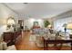Cozy living room with hardwood floors, floral print furniture, and natural light at 10290 Buck Rd, Orlando, FL 32817