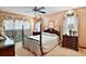 Spacious main bedroom with four poster bed, floral curtains, and matching dresser at 10290 Buck Rd, Orlando, FL 32817