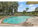 Outdoor pool and backyard featuring mature trees with a fence around the property at 10290 Buck Rd, Orlando, FL 32817