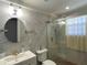 Modern bathroom with a frameless shower and marble tile at 910 Lake Ave, Edgewater, FL 32132