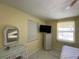 Cozy bedroom with a white dresser and vanity at 910 Lake Ave, Edgewater, FL 32132