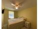 Bright bedroom with a queen-size bed and updated flooring at 910 Lake Ave, Edgewater, FL 32132