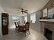 Bright dining room with a fireplace and block windows at 910 Lake Ave, Edgewater, FL 32132