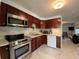 Updated kitchen, stainless steel appliances, and dark wood cabinets at 910 Lake Ave, Edgewater, FL 32132