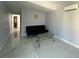 Living room with a sleek black sofa and marble-look flooring at 910 Lake Ave, Edgewater, FL 32132