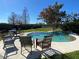 Backyard oasis featuring a kidney-shaped pool and patio furniture at 910 Lake Ave, Edgewater, FL 32132