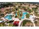 Aerial view of a community pool area with palm trees and lounge chairs at 3204 Calabria Ave # 443, Davenport, FL 33897