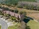 Aerial view showcasing townhouses, landscaping, and surrounding nature at 3204 Calabria Ave # 443, Davenport, FL 33897