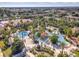 Aerial view of resort-style pool with water features, palm trees, and surrounding community at 3204 Calabria Ave # 443, Davenport, FL 33897