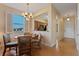 Cozy dining area with round table and chairs, view into kitchen, and hardwood floors at 3204 Calabria Ave # 443, Davenport, FL 33897