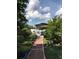 Brick pathway leads to covered patio and lush greenery at 3115 Albert St, Orlando, FL 32806