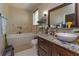 Bathroom with soaking tub and granite vanity at 3115 Albert St, Orlando, FL 32806